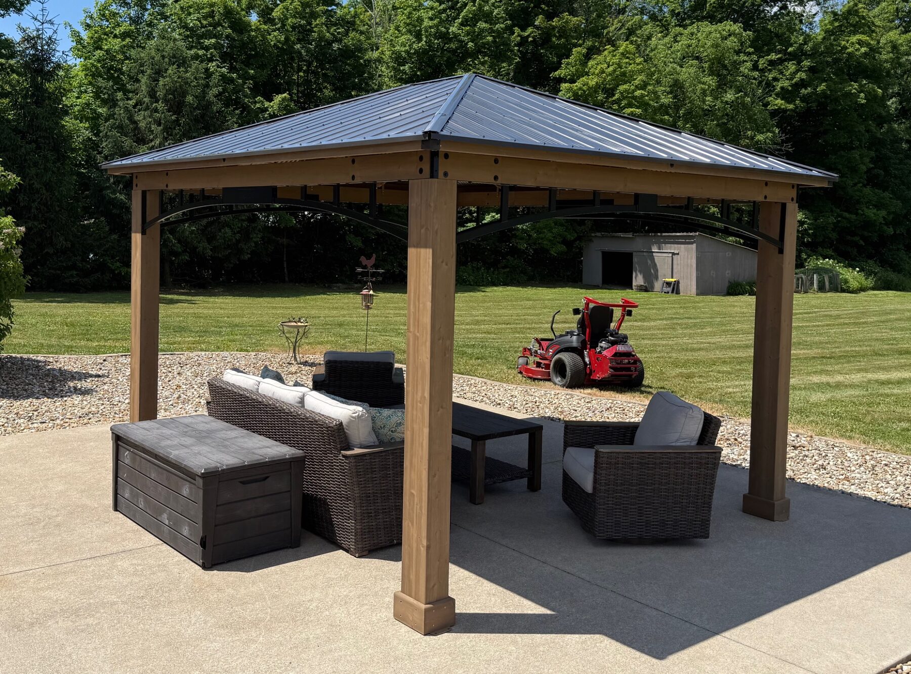 Completed wood gazebo with a metal roof on a backyard patio