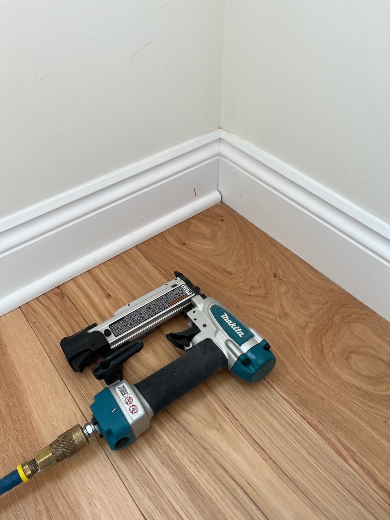 Finish nailer beside newly installed detailed baseboard trim